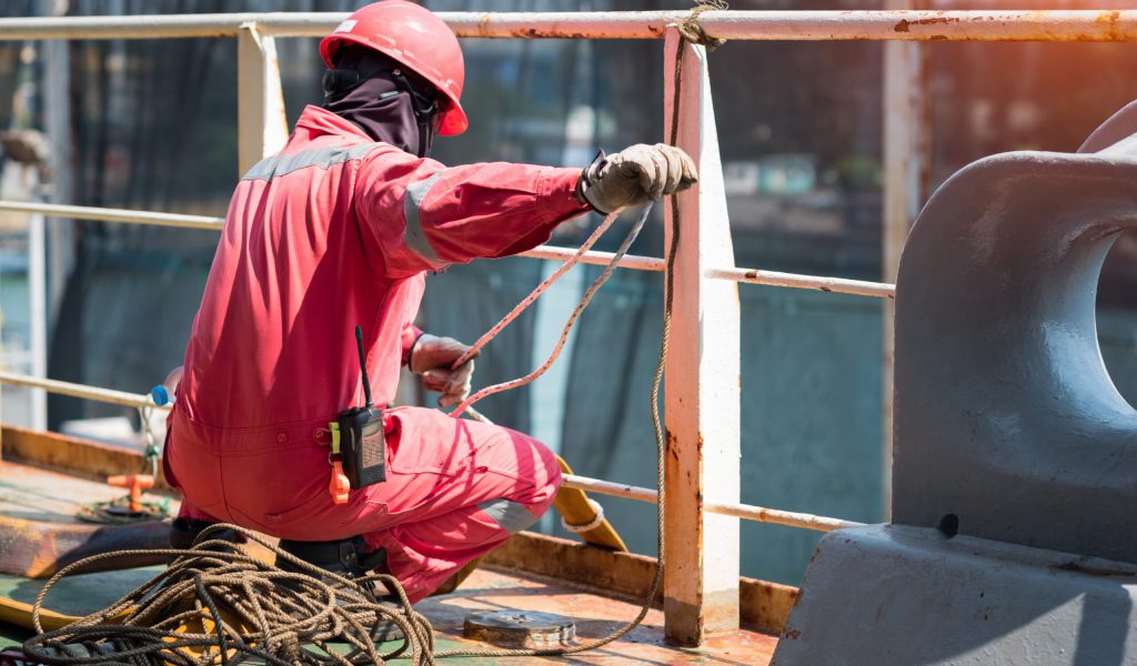 Construction worker wearing safety harness and safety line working at high place and inspection of the safty berthing along side